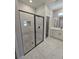 Modern bathroom with walk-in shower featuring gray marble tiling and sleek black fixtures at 2699 Sw 161St Loop, Ocala, FL 34473