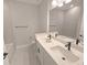 Bathroom featuring a white dual sink vanity with black faucets, mirror, and gray tile at 2699 Sw 161St Loop, Ocala, FL 34473