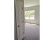 Bedroom with a large window and neutral-toned carpet flooring at 2699 Sw 161St Loop, Ocala, FL 34473