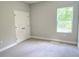 Bedroom featuring a neutral gray wall paint color, gray carpet, and a double door closet at 2699 Sw 161St Loop, Ocala, FL 34473