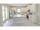 Bright kitchen featuring white cabinets, stainless steel appliances, and a convenient center island at 2699 Sw 161St Loop, Ocala, FL 34473