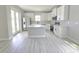 A well-lit kitchen with white cabinets, stainless steel appliances, and a center island at 2699 Sw 161St Loop, Ocala, FL 34473