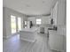 Kitchen features white cabinets, stainless appliances, and a center island that overlooks the backyard at 2699 Sw 161St Loop, Ocala, FL 34473