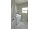 Laundry room featuring a window, modern washer and dryer, and gray flooring at 2699 Sw 161St Loop, Ocala, FL 34473