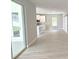 Open-concept living area featuring wood-look flooring, a sliding glass door and a modern kitchen at 2699 Sw 161St Loop, Ocala, FL 34473
