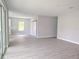 Spacious living room with gray walls, light-colored wood flooring, and lots of natural light at 2699 Sw 161St Loop, Ocala, FL 34473