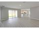Bright and open living space with hard surface floors and access to the kitchen and backyard at 2699 Sw 161St Loop, Ocala, FL 34473