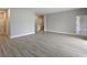 Bright living room with light gray walls, white trim, and wood-look floors creating an inviting space at 2699 Sw 161St Loop, Ocala, FL 34473