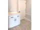 Mudroom features white cabinets with a white countertop, sleek black hardware, and an adjacent door at 2699 Sw 161St Loop, Ocala, FL 34473