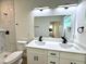 Bathroom featuring a double sink vanity, modern fixtures and shower with tile surround at 319 Anchovie Ct, Poinciana, FL 34759