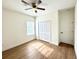 This bedroom has a ceiling fan, closet and wood-look flooring at 319 Anchovie Ct, Poinciana, FL 34759