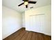 Cozy bedroom with a ceiling fan, hardwood floors, and ample closet space at 319 Anchovie Ct, Poinciana, FL 34759