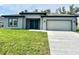 Charming single-story home with a well-maintained lawn and a two-car garage at 319 Anchovie Ct, Poinciana, FL 34759