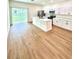 Bright kitchen features white cabinets, stainless steel appliances and island with quartz countertops at 319 Anchovie Ct, Poinciana, FL 34759