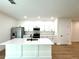 Bright kitchen with a center island, stainless steel appliances, and white cabinetry at 319 Anchovie Ct, Poinciana, FL 34759