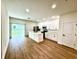 Bright kitchen features white cabinets, stainless steel appliances and island with quartz countertops at 319 Anchovie Ct, Poinciana, FL 34759