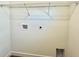 A minimalistic laundry room featuring connections for washer and dryer at 319 Anchovie Ct, Poinciana, FL 34759
