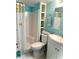 Bright bathroom featuring blue walls, shower-tub combination, white vanity and open shelving for storage at 3207 Westridge Blvd # 104, Orlando, FL 32822