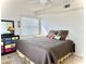 Cozy bedroom with a plush bed, ceiling fan, and colorful dresser beneath a window at 3207 Westridge Blvd # 104, Orlando, FL 32822