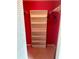 Walk in closet with custom shelving and bright red walls at 3207 Westridge Blvd # 104, Orlando, FL 32822