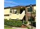 Inviting two-story condo building with lush landscaping and visible unit numbers at 3207 Westridge Blvd # 104, Orlando, FL 32822