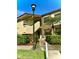 Inviting two-story condo building with lush landscaping and visible unit numbers at 3207 Westridge Blvd # 104, Orlando, FL 32822