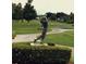 Scenic view of a golf course with a decorative statue of a golfer in mid swing at 3207 Westridge Blvd # 104, Orlando, FL 32822