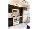 Efficient kitchen layout with ample cabinet space and white appliances at 3207 Westridge Blvd # 104, Orlando, FL 32822