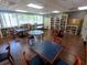 Reading room with bookshelves, tables, and chairs for residents at 3207 Westridge Blvd # 104, Orlando, FL 32822