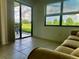 Living room with sliding glass door and window overlooking the surrounding outdoor landscape at 3207 Westridge Blvd # 104, Orlando, FL 32822