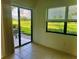 Sunlit patio showcasing sliding door access and scenic golf course views at 3207 Westridge Blvd # 104, Orlando, FL 32822