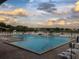 Large swimming pool area, complete with lounge chairs and tables by the water's edge at 3207 Westridge Blvd # 104, Orlando, FL 32822