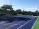 Outdoor tennis court with green and blue surfaces and a green net at 3207 Westridge Blvd # 104, Orlando, FL 32822