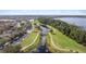 Aerial view of neighborhood walking paths alongside a waterway and lake at 3426 Schoolhouse Rd, Harmony, FL 34773