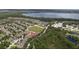 Gorgeous aerial view showcases the neighborhood, trees, and lake at 3426 Schoolhouse Rd, Harmony, FL 34773