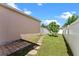 Landscaped backyard featuring a stone pathway and a privacy fence at 3426 Schoolhouse Rd, Harmony, FL 34773