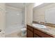 Cozy bathroom featuring a shower-tub combo, neutral tiling, and a granite vanity with a modern sink at 3426 Schoolhouse Rd, Harmony, FL 34773