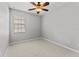 A bright bedroom featuring carpet floors and a large window at 3426 Schoolhouse Rd, Harmony, FL 34773