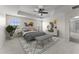 Staged bedroom boasting a tray ceiling, ceiling fan, stylish decor, and ample natural light at 3426 Schoolhouse Rd, Harmony, FL 34773