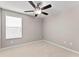 Neutral bedroom with carpet, ceiling fan, and a bright window for great natural light at 3426 Schoolhouse Rd, Harmony, FL 34773