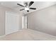 Neutral bedroom with plush carpeting, a ceiling fan, and a spacious closet for optimal storage at 3426 Schoolhouse Rd, Harmony, FL 34773
