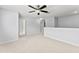 Bonus room features neutral walls, carpet, ceiling fan and multiple doors at 3426 Schoolhouse Rd, Harmony, FL 34773