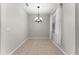 A dining room featuring tile floors and a modern chandelier at 3426 Schoolhouse Rd, Harmony, FL 34773