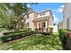 A charming two-story home boasts lush green grass, vibrant landscaping, and a sunny facade at 3426 Schoolhouse Rd, Harmony, FL 34773