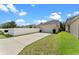 Exterior view of home featuring a two-car garage and a long driveway at 3426 Schoolhouse Rd, Harmony, FL 34773