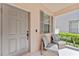 Inviting front porch with seating offers a cozy spot to enjoy the outdoors at 3426 Schoolhouse Rd, Harmony, FL 34773