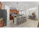 Kitchen featuring a granite island with bar stool seating, and modern stainless-steel appliances at 3426 Schoolhouse Rd, Harmony, FL 34773