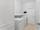 Clean laundry room featuring a washer and dryer with tile flooring at 3426 Schoolhouse Rd, Harmony, FL 34773