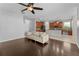 Open floor plan with a modern living room featuring hard wood floors and a ceiling fan at 3426 Schoolhouse Rd, Harmony, FL 34773
