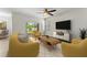 Bright living room featuring comfortable seating, sliding glass door to the backyard, and large tv at 3426 Schoolhouse Rd, Harmony, FL 34773